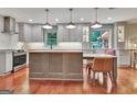 Renovated kitchen featuring pendant lighting, an island with seating, and stainless steel appliances at 104 Whisper Trce, Peachtree City, GA 30269