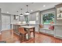 Beautiful kitchen featuring grey cabinets, stainless appliances, a window bench and wood floors at 104 Whisper Trce, Peachtree City, GA 30269