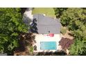 Aerial view showcasing a home with a backyard pool, patio area, and lush green surroundings at 125 Wendell Ct, Fayetteville, GA 30215