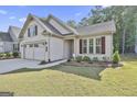 Charming one-story home featuring a well-kept lawn and manicured landscaping at 430 Silverbell Ct, Peachtree City, GA 30269