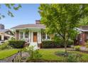 Beautifully landscaped front yard with mature tree enhancing curb appeal at 239 Kings Hwy, Decatur, GA 30030