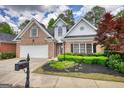 Beautiful brick home with landscaped front yard, healthy shrubs and attractive mailbox at 1880 Hickory Station Cir, Snellville, GA 30078
