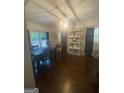 Bright dining room featuring a modern light fixture, dark hardwood floors, and a view to backyard at 288 Harper Se Rd, Atlanta, GA 30315