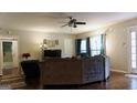 Comfortable living room featuring large windows and a stylish ceiling fan at 288 Harper Se Rd, Atlanta, GA 30315