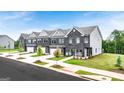 Modern townhomes featuring brick exteriors, attached garages, and professional landscaping at 240 Epping Dr, Stockbridge, GA 30281
