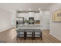 Modern kitchen with stainless steel appliances, granite counters, and center island with bar stool seating at 240 Epping Drive, Stockbridge, GA 30281