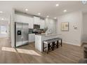 Bright kitchen features stainless steel appliances, white cabinets, and a large island with seating at 240 Epping Drive, Stockbridge, GA 30281