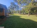 Spacious, well-manicured backyard with lush trees and a neatly kept lawn, offering plenty of space at 150 Park Timbers Drive, Sharpsburg, GA 30277