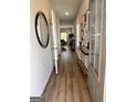 Inviting foyer featuring wood-look floors, contemporary decor, and a welcoming entrance hall with a clear view to the living room at 256 Epping Drive, Stockbridge, GA 30281