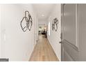 Entryway featuring light colored laminate flooring, light colored walls, and decorative wall art at 256 Epping Drive, Stockbridge, GA 30281