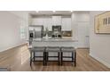 Stylish kitchen featuring a center island with seating, stainless steel appliances, and modern finishes at 256 Epping Drive, Stockbridge, GA 30281