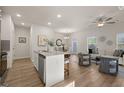 Open-concept living space with hardwood floors, modern furnishings, and stainless steel appliances at 256 Epping Drive, Stockbridge, GA 30281