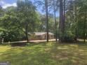 A charming house surrounded by lush green trees in a serene wooded setting at 367 Frashier Rd, Carrollton, GA 30116