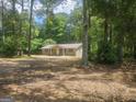 A charming house surrounded by lush green trees in a serene wooded setting at 367 Frashier Rd, Carrollton, GA 30116