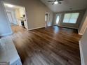 Cozy living room featuring new wood floors, neutral paint, and seamless access to the kitchen at 120 Lazy Hollow Ln, Covington, GA 30016