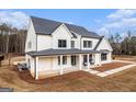 Beautiful exterior featuring black trim accents, white siding and a cozy covered porch with hanging swing chairs at 260 Cicely Way, Tyrone, GA 30290