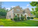 This beautiful home boasts a well-maintained lawn, mature landscaping, and a classic architectural design at 6533 Waterford Sw St, Atlanta, GA 30331