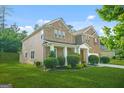 This beautiful home boasts a well-maintained lawn, mature landscaping, and a classic architectural design at 6533 Waterford Sw St, Atlanta, GA 30331