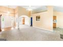 Spacious living room featuring carpet, neutral colored walls and plenty of natural light at 2340 Landrum Ct, Lawrenceville, GA 30043