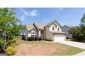 Inviting two-story home with a blend of stucco and stone, accented by a well-maintained lawn at 2805 Topaz Rd, Riverdale, GA 30296