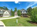 Spacious home with a large front yard and long driveway, surrounded by mature trees at 5016 Brass Ct # 195, Locust Grove, GA 30248