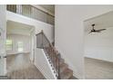 Elegant foyer with a staircase featuring a wrought iron railing and views of the living area at 5016 Brass Ct, Locust Grove, GA 30248