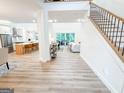 Bright and airy foyer featuring an open floor plan with hardwood floors and staircase at 3180 Lee Dr, Buford, GA 30518