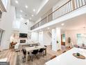 Spacious open-concept living room boasts a fireplace, vaulted ceilings, and dining area at 3180 Lee Dr, Buford, GA 30518