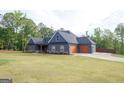 Stylish home with a large, manicured lawn and an attached two-car garage, offering both convenience and curb appeal at 227 Wet Wood Ct, Fairburn, GA 30213