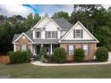 Beautiful two-story home featuring a brick and siding exterior, well-maintained landscaping, and a classic design at 150 Murphy Creek Ln, Fayetteville, GA 30215