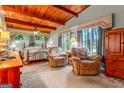Inviting bedroom with wood beam ceiling, comfortable armchairs, and large windows offering scenic views and creating a relaxing retreat at 1813 Freeman Rd, Jonesboro, GA 30236
