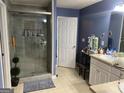 Bathroom with a spacious glass enclosed shower and ample vanity storage at 565 Miles Ct, Locust Grove, GA 30248