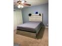 Bedroom with light-colored floors, closet, and fan at 565 Miles Ct, Locust Grove, GA 30248