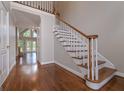 Bright foyer with hardwood floors, a staircase, and views into a spacious living area at 5028 Chapel Lake Cir, Douglasville, GA 30135