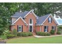 Stunning brick home featuring a large front lawn, mature landscaping, and a welcoming facade at 5028 Chapel Lake Cir, Douglasville, GA 30135