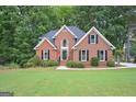 Charming two-story brick home with manicured lawn and mature landscaping at 5028 Chapel Lake Cir, Douglasville, GA 30135