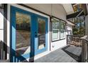 Inviting front porch featuring bright blue double doors and stylish lighting, adding curb appeal and charm at 7428 Mockingbird Trl, Riverdale, GA 30274