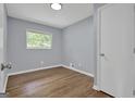 A cozy bedroom with beautiful hardwood floors, light grey walls, and natural light from the window at 2315 Shancey Ln, South Fulton, GA 30349