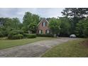 Charming brick home with a well-manicured lawn and a curved driveway at 2329 Lochinver Sw Ln, Conyers, GA 30094