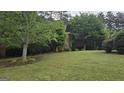 Brick home with manicured lawn and mature trees offering privacy at 2329 Lochinver Sw Ln, Conyers, GA 30094