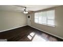 Bright living room featuring hardwood floors, a ceiling fan, and a large window at 3317 Renault Se Rd, Atlanta, GA 30354