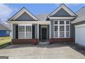 Close up on the front door of a well maintained home with a brick water table at 3634 Cape Ln, Conyers, GA 30013
