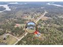 Aerial shot showcases property with house in a circle on a wooded lot, conveniently located by main road at 3911 Peeksville Rd, Locust Grove, GA 30248
