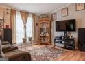 Comfortable living room featuring wood floors, neutral walls, and large windows at 714 Yates Rd, Bowdon, GA 30108
