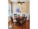 Cozy dining area with wainscoting, hardwood floors, and a charming round table with seating for four at 511 Bonneset Ct, Canton, GA 30114