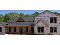 View of new home under construction showing roof, porch and window placement at 95 Cambridge, Covington, GA 30014