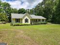 Charming single-story home with a well-manicured lawn and mature landscaping at 350 Lakeview Dr, Brooks, GA 30205