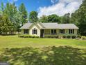 Charming single-story home with a well-manicured lawn and mature landscaping at 350 Lakeview Dr, Brooks, GA 30205