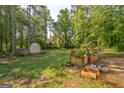 Expansive backyard featuring a shed and garden beds, creating a serene outdoor space at 4333 Deer Ridge Ct, Lilburn, GA 30047