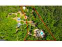 Aerial view of a large property featuring a pool, pond, and surrounded by lush greenery and trees at 3313 Henson Ln, Stockbridge, GA 30281